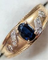 Front view showing oval blue sapphire and diamond accents