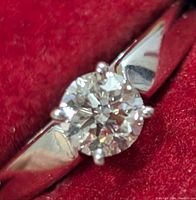 Front view of ring showing round brilliant diamond and band