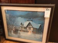 Framed print of winter hotel scene with carriage in front, showing signature and number on print.