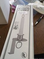 Photo of a boxed window candle showing product image, features, and UL safety mark.