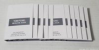 Ten individual white paper cards labeled 'Tom Ford Beau De Jour Eau de Parfum vaporisateur spray .05 fl. oz. / 1.5 ml', laid out flat in a row.