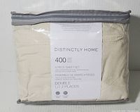 Packaged 4 piece sheet set by Distinctly Home, showing label with product info and brand name.