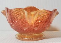Front angled view showing scalloped rim, pineapple textured pattern, and marigold color glass bowl.