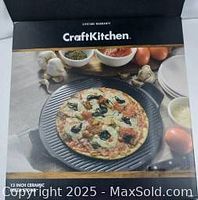 Box packaging of Craft Kitchen pizza stone showing cooked pizza photo for illustration.