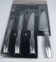Full view of Prime Chef 4-piece knife set in original packaging, showing four knives with stainless steel blades and metallic handles.