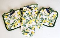 Four square pot holders and one oven mitt all with lemon print fabric and green trim, new condition, arranged on white background