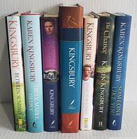 Full view of 7 hardcover books by Karen Kingsbury showing spines and covers, including large slipcase edition