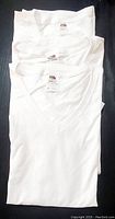 Stack of three white V-neck T-shirts showing overall condition and color.