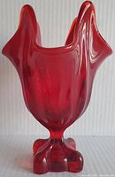Front view of deep red Viking Glass vase with four lobed base and swung rim showing smooth glossy finish and vivid red color.