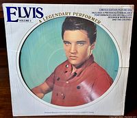 Front cover of Elvis Presley A Legendary Performer Volume 3 12-inch picture disc LP with large image of Elvis Presley in red shirt.