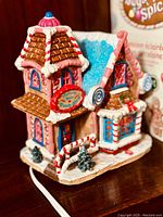 Close-up image showing detailed candy-themed exterior decoration of the Molasses Falls Candy Shop porcelain lighted house.