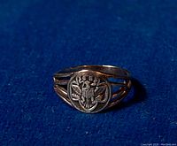 Full view of the vintage Art Deco sterling silver Girl Scout Association ring front and side showing detailed eagle crest and split band design.