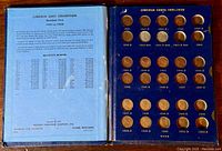 Open book showing Lincoln cent slots from 1941-1950 with coins mostly in place and a few missing slots.