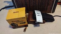 Kodak Brownie Hawkeye camera yellow box and leather case with tag