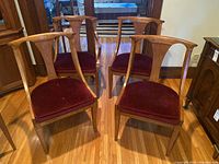 Four chairs arranged in front of cabinet