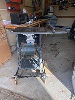 Front view of Rockwell table saw model 6200 with motor and rolling base, placed in garage environment.