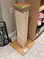 Front side view of scratching post showing sisal rope wrapped central column and wooden base.