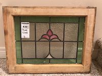 Full view of the stained glass panel showing wood frame and colored glass design