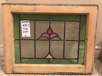 Front view of stained glass panel showing design and wooden frame