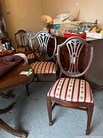 Group view of four chairs next to dining table