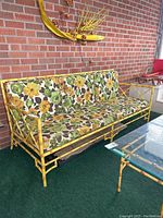 Front view of sofa with all cushions in place against brick wall