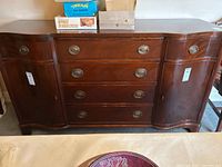 Front view of cherry finish buffet showing six drawers and two doors