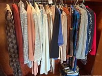 Full rack view of assorted ladies clothing including skirts, jackets, and blazers in various colors and patterns