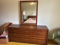 Frontal view of dresser with attached mirror on top