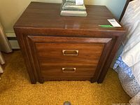 Front view of nightstand showing two drawers and metal pulls