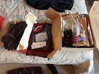 Overview of two pairs of gloves and a box of scarves and garters