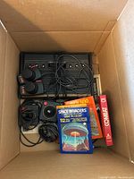 Box containing console, controllers, game cartridges