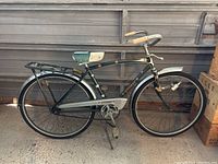 Side view of the entire vintage Eaton's Glider bike showing frame, wheels, handlebar, seat, and rear rack.