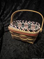Front and top view showing the basket with patriotic red, blue, and natural woven wood colors and cloth liner with American flag star and stripe pattern.