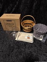 Photo showing the basket, cloth liner, clear plastic liner, Certificate of Authenticity, and original box.