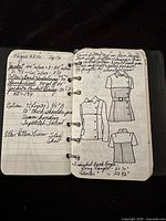 Open notebook showing pages with handwritten seamstress measurements and clothing design sketches.