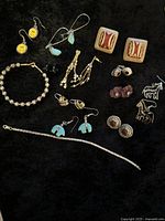 Full overview of the vintage mixed jewelry lot including earrings and bracelets.