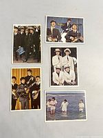 Five 1964 Beatles Color Cards by Topps trading cards showing different Beatles group portraits and individual shots. Color images on front, stored in plastic sleeves.