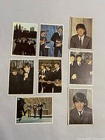Front side of 8 Beatles color cards showing various band members in suits with instruments and as portraits