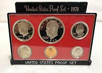Front photo of 1978-S United States proof coin set housed in clear plastic display with red insert showing six coins: Eisenhower dollar, half dollar, quarter, dime, nickel, and penny.