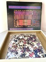 Opened box showing plastic-bagged 540 puzzle pieces with microprocessor image on box cover.