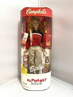Full view of original packaged Campbell's Alphabet Soup Barbie doll with accessories visible in packaging