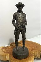 Full view of the Michael Garman bronze cowboy sculpture standing roughly 8.75 inches tall, showing detailed western attire and stance.