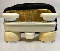 Front view of the cream-colored Pinecrest opera glasses showing textured grips and focusing knob.