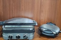 Cuisinart Griddler showing front control knobs and removable plates with handle and stainless steel finish