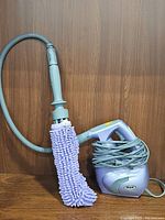 Shark SC630W handheld steam cleaner with hose and chenille microfiber mop attachment, coiled power cord visible.