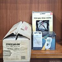 Statesman Model 500-1 Electric Fencer boxed with Car MD 2100 code reader and diagnostic engine analyzer in manufacturer packaging.