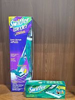 Swiffer WetJet starter kit in its original packaging with box of Swiffer cloths in front.