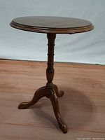 Full view of antique Pennsylvania House mahogany pedestal table showing the round top, turned pedestal column and tripod legs with claw feet.