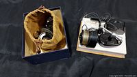 Vintage Garcia Mitchell 300 spinning reel inside blue box with brown cloth pouch.