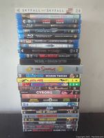 Stacked Blu-ray and DVD collection featuring various movies and TV series titles.